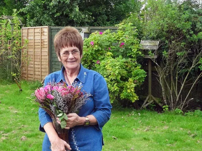 grandma holding flowers in backyard grandma holding flowers in backyard